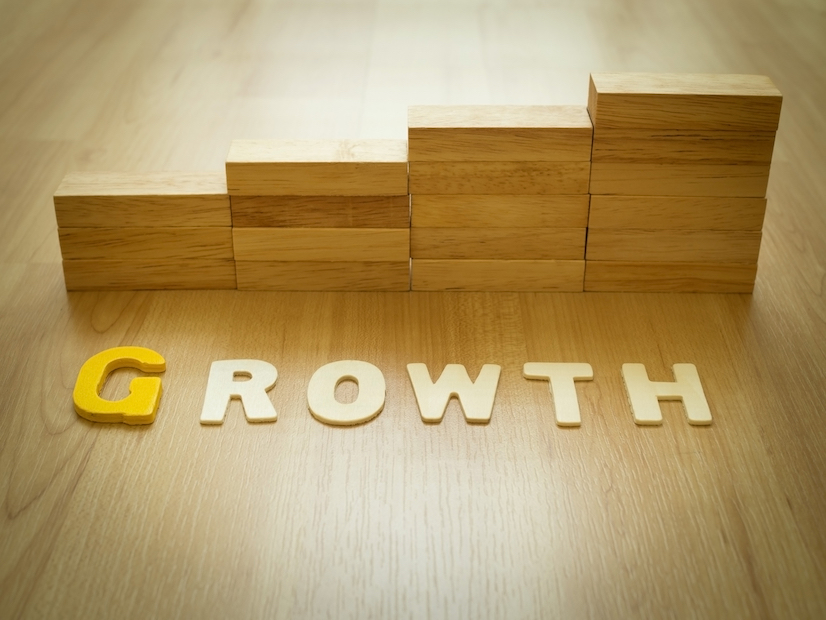 Growth word on wooden floor with wood block stacking as step stair in background. Business concept for growth success process. Growth in career path concept. Vintage filter and selective focus.