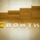 Growth word on wooden floor with wood block stacking as step stair in background. Business concept for growth success process. Growth in career path concept. Vintage filter and selective focus.